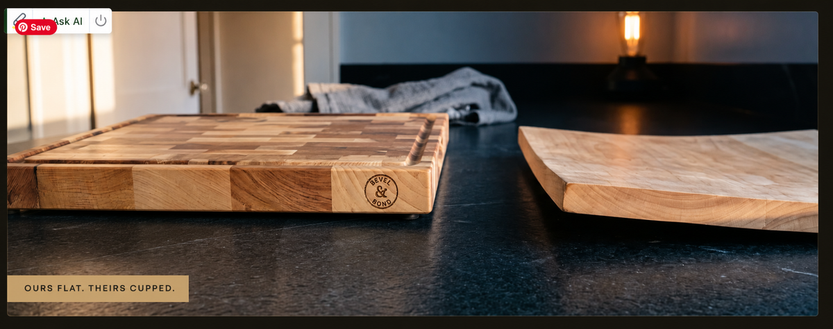 The 1.75 inch edge profile of the Bevel and Bond end-grain hard maple cutting board on a dark countertop, shown beside a chef's knife and a tin of Board Balm.