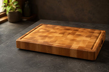 Bevel and Bond end-grain hard maple cutting board with juice groove on a dark kitchen counter