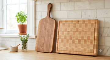 Cutting board with a carved handle beside a plain rectangular maple board