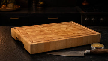 End-grain hard maple cutting board showing its checkerboard surface on a kitchen counter