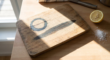 Dark iron tannin stains on a wooden cutting board with lemon and salt