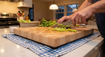 Cutting board held steady on a damp towel with non-slip rubber feet