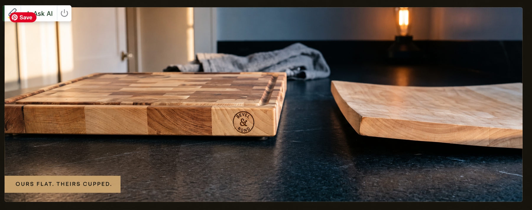 The 1.75 inch edge profile of the Bevel and Bond end-grain hard maple cutting board on a dark countertop, shown beside a chef's knife and a tin of Board Balm.